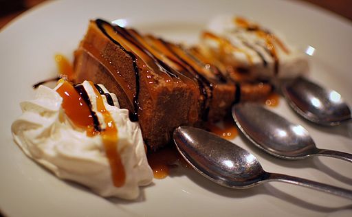 slice of cheesecake with caramel sauce and 3 spoons