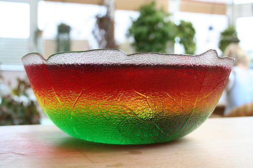 picture of red, green, and yellow jello layered in a crystal bowl.